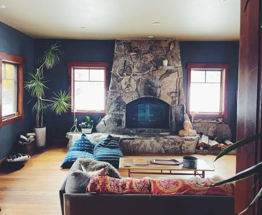 living room with natural stone fireplace