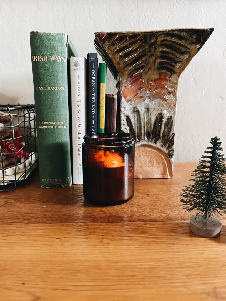 scented candle near books