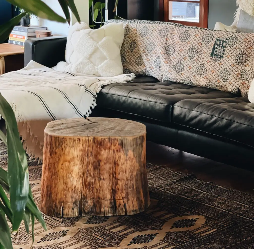 tree stump table near couch on rug