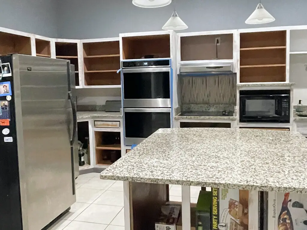 empty kitchen cabinetry with base coat primer