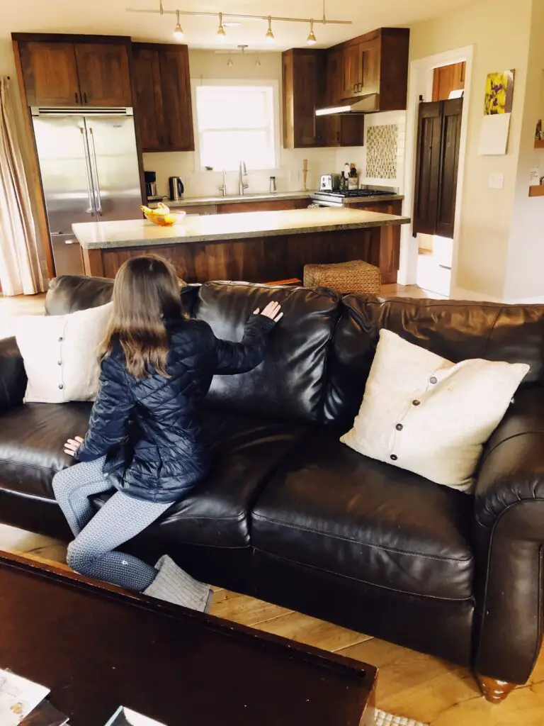 girl sitting on couch with her back to the camera