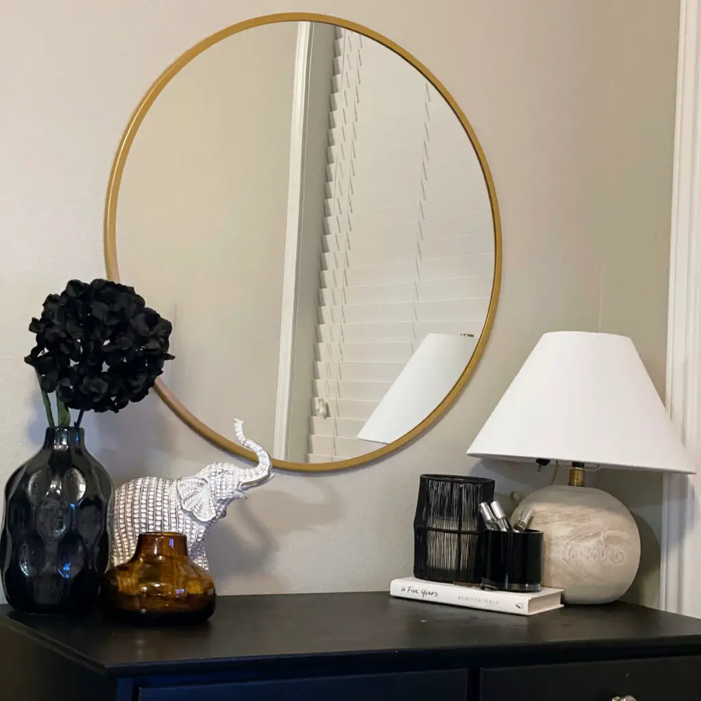 Neutral dresser decor with cup to hold roll-on perfume
