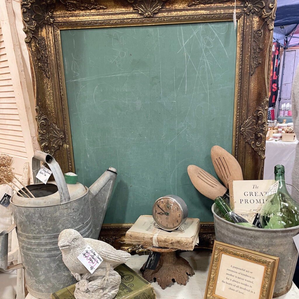 gold framed chalk board with rustic, antique decor accents
