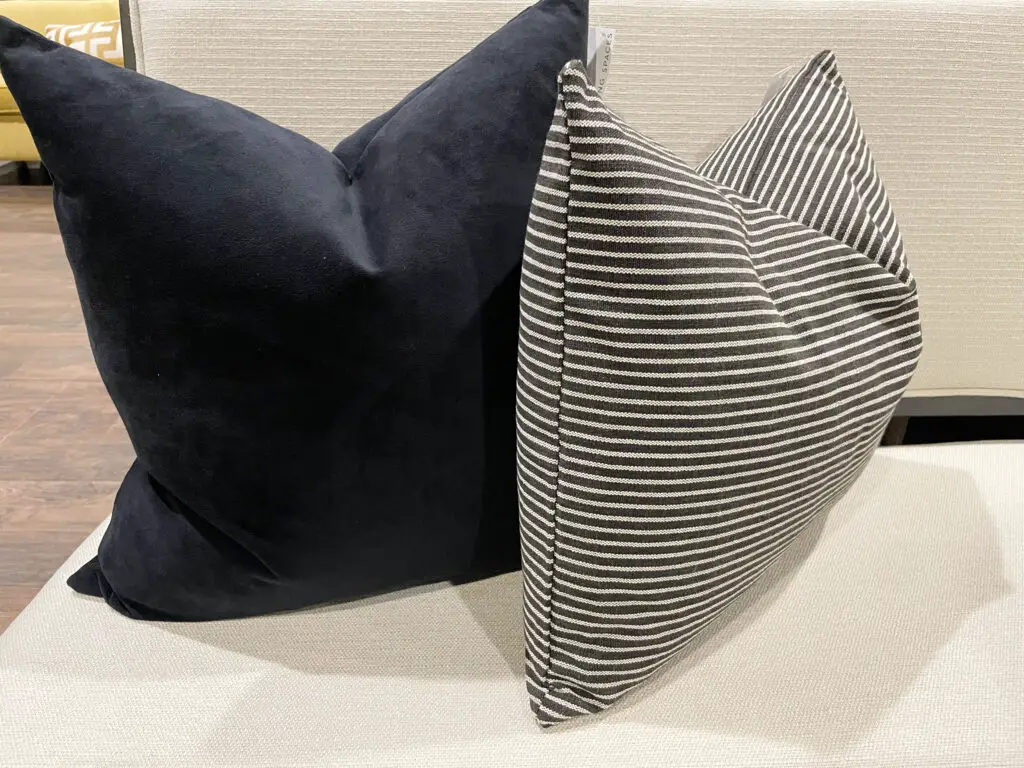 Black velvet and black and white striped throw pillows