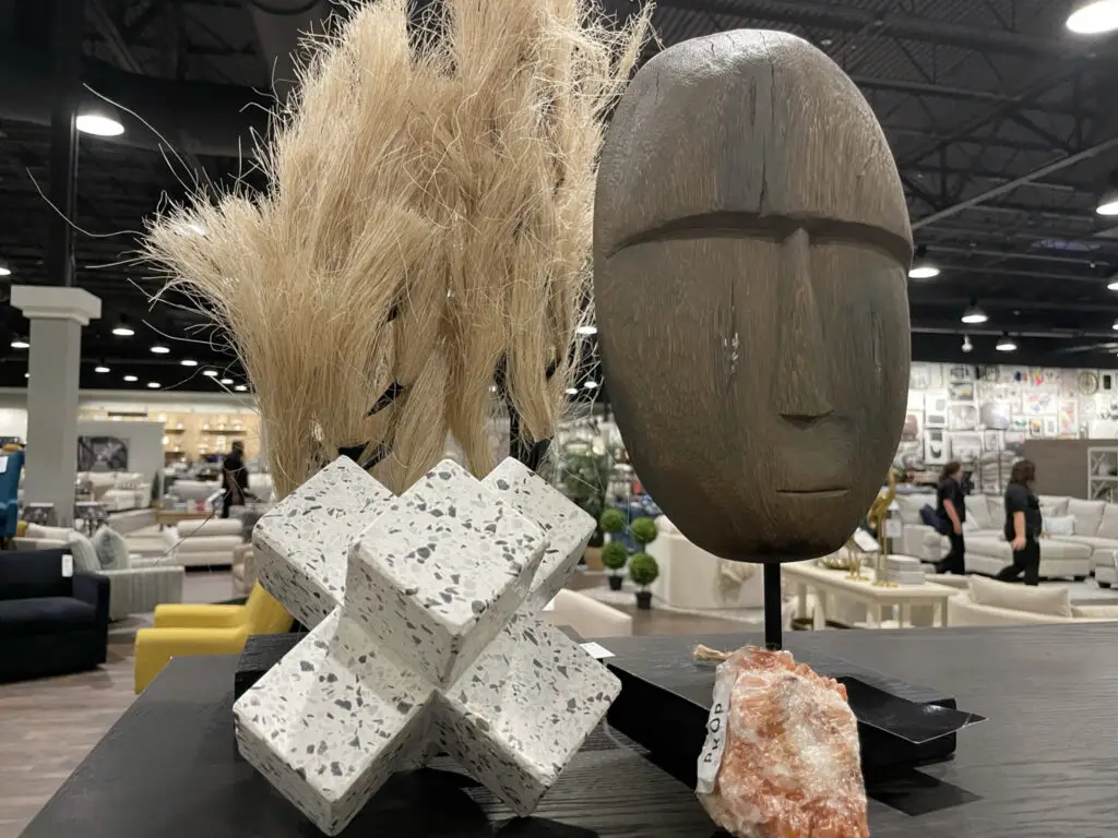Wooden mask, abstract sculpture, and rock shelving decor