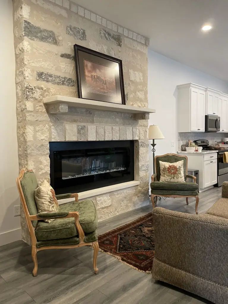 Large stone fireplace just off the kitchen