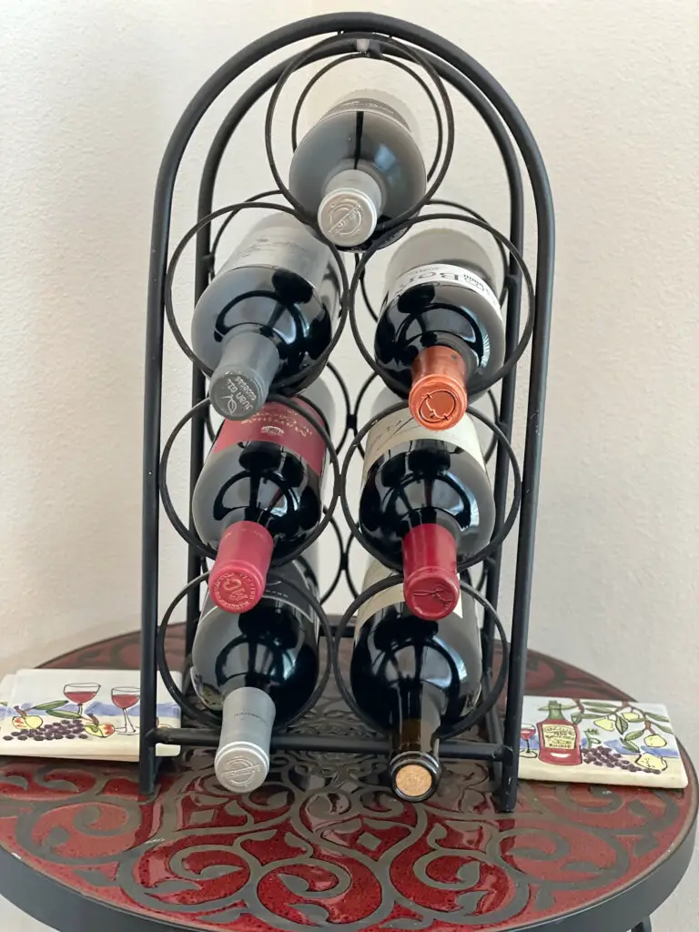 Wine rack filled with bottles on a small side table