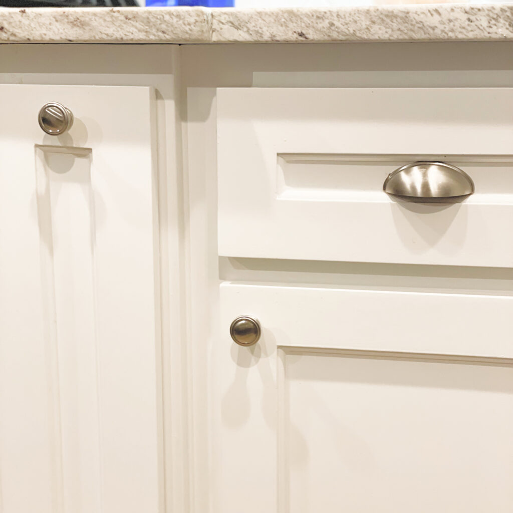 White cabinets with a mix of sliver knobs and pulls