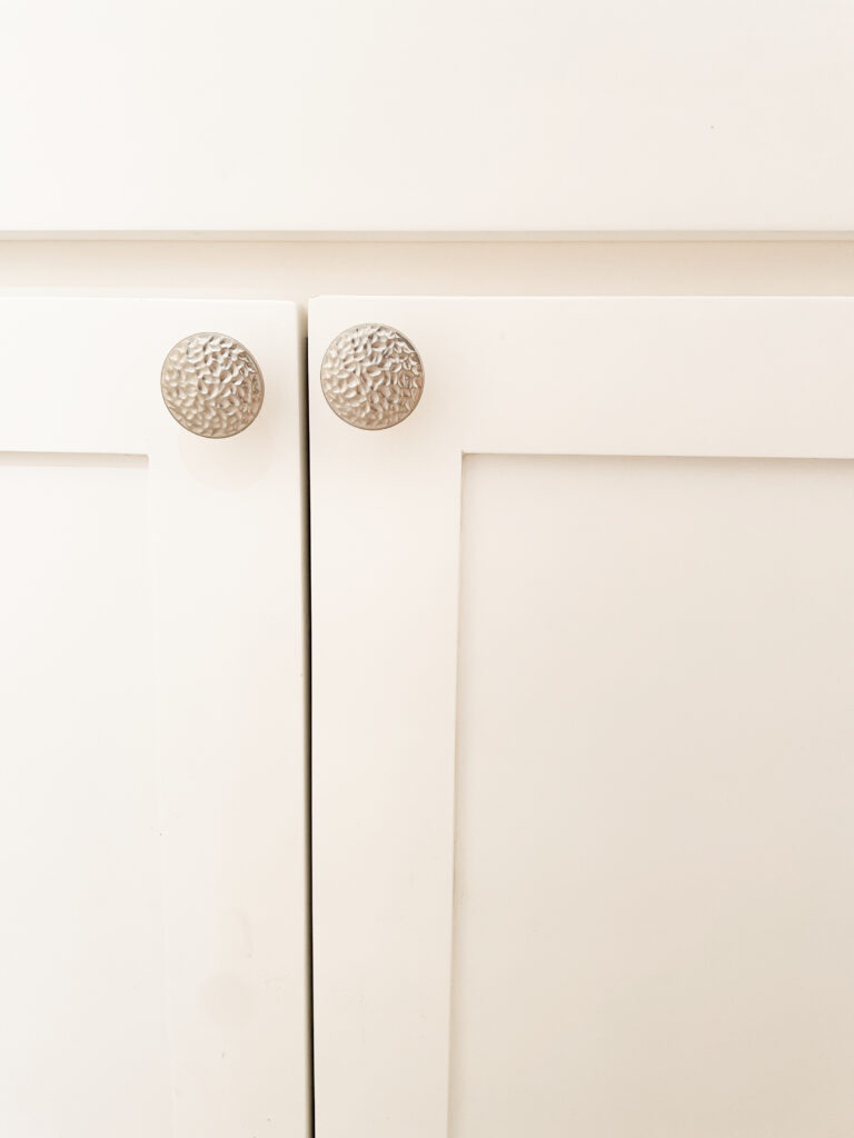 White cabinets with with textured, silver knobs