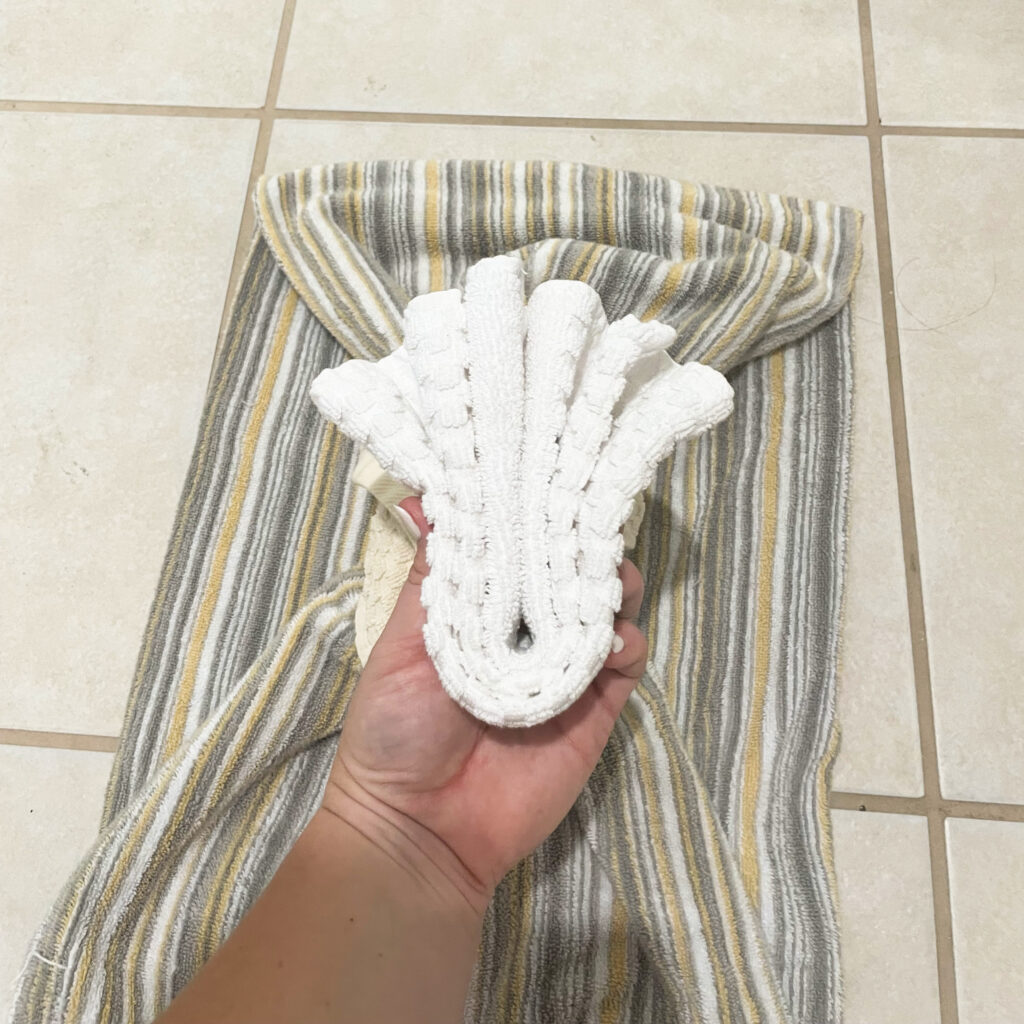 White wash cloth folded like an accordian and then folded in half