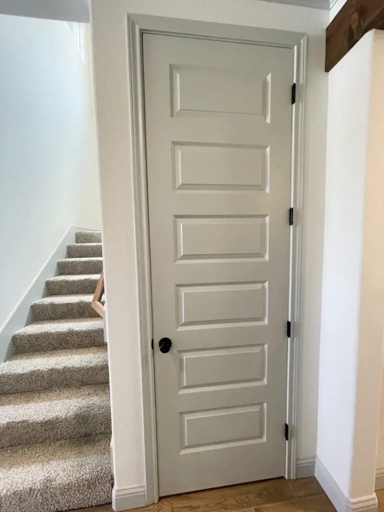grey painted door and trim with black hardware