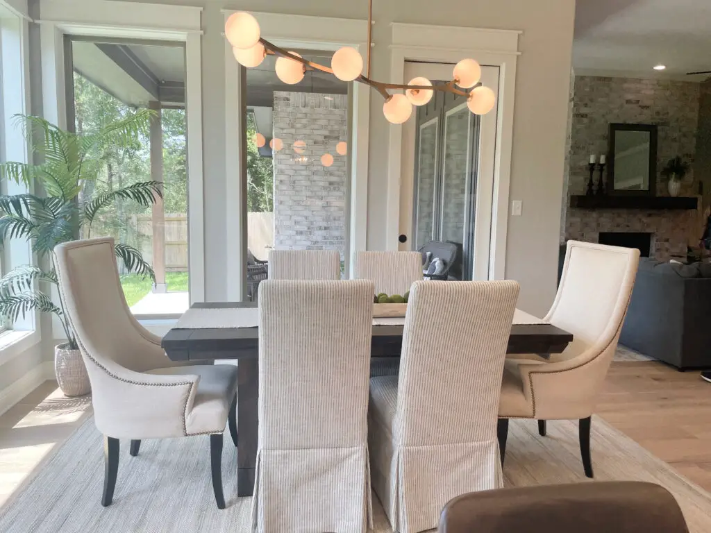 grey and white dining room set, with polished brass abstract light fixture