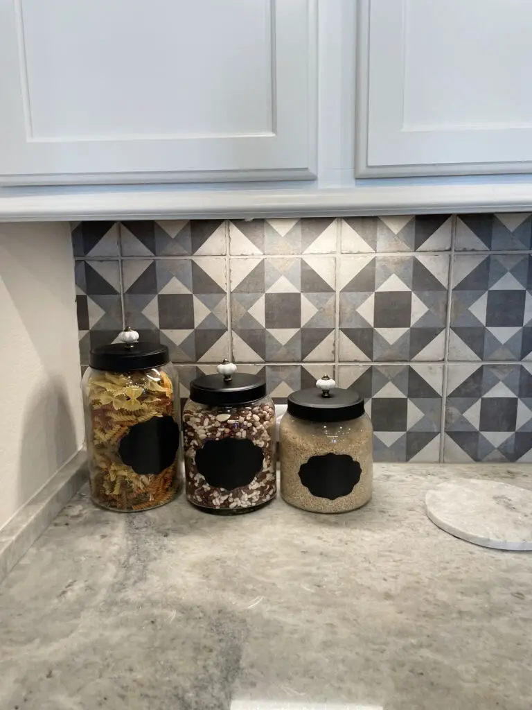 Black, blue and white abstract pattern with square tiles on the kitchen backsplash