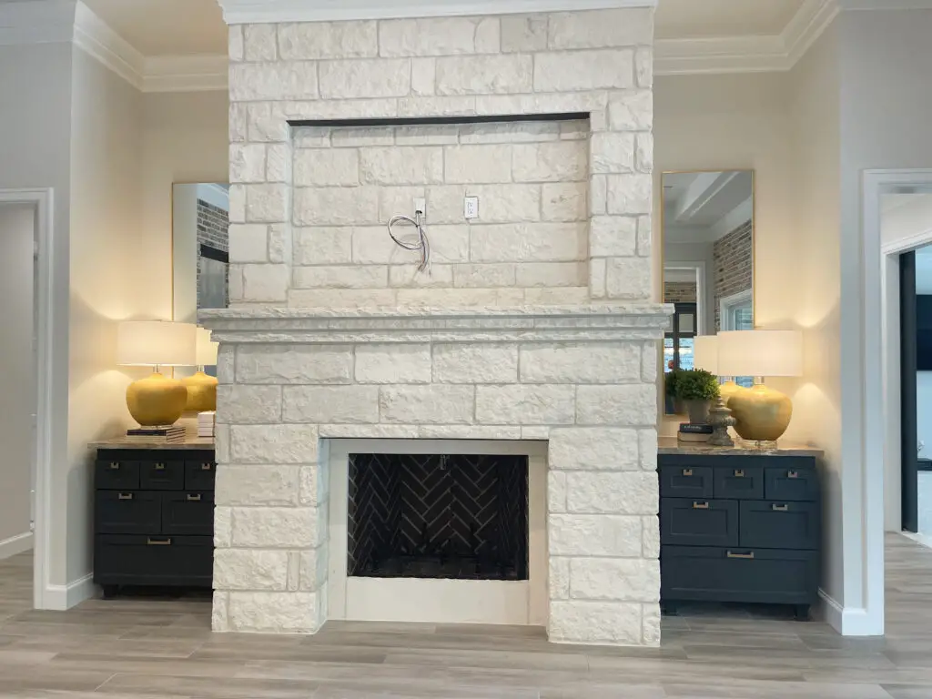 White stone fireplace with television cut out