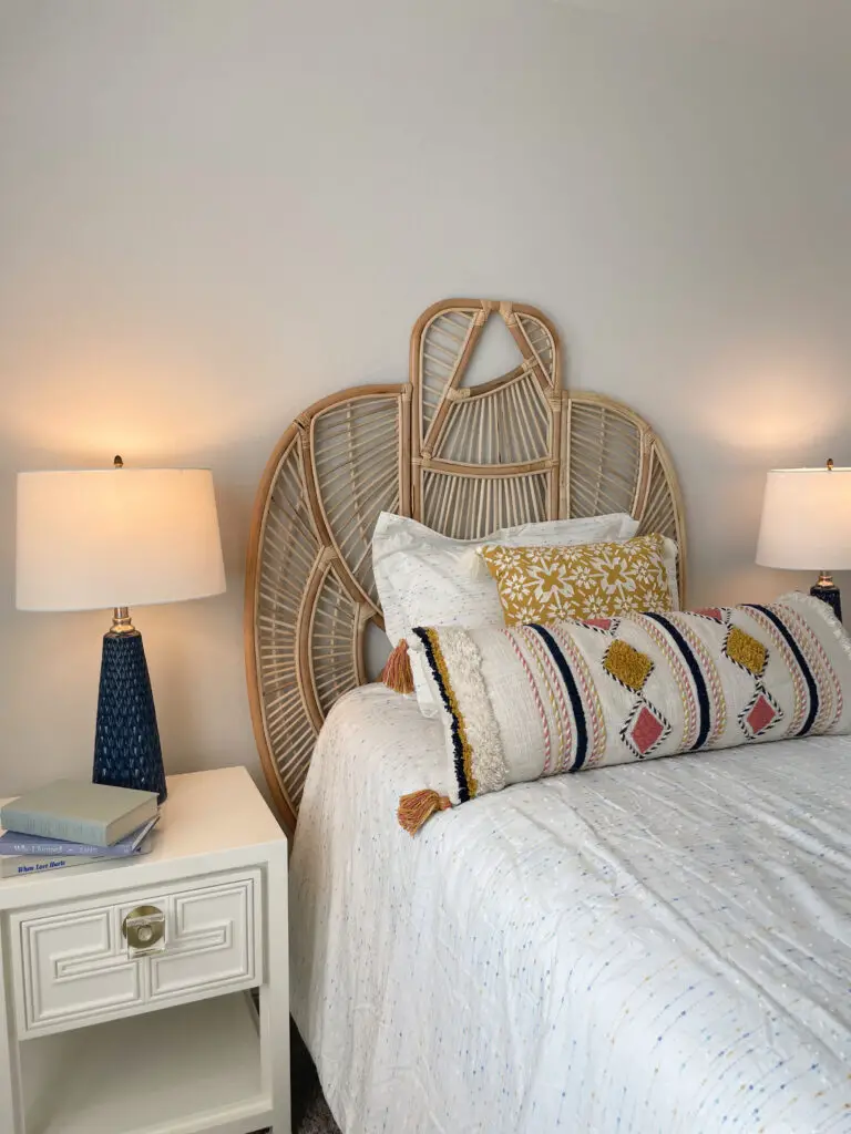 Brightly colored bedding and accents with white nightstand with gold hardware