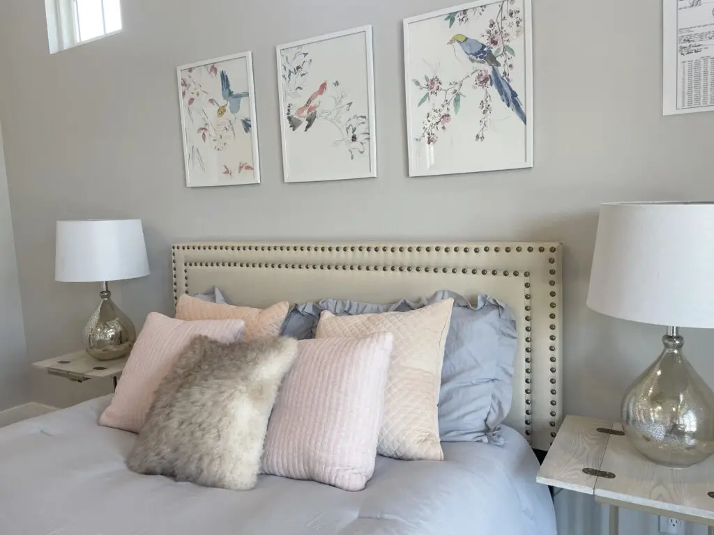 Pink & blue bedroom with white washed nightstands