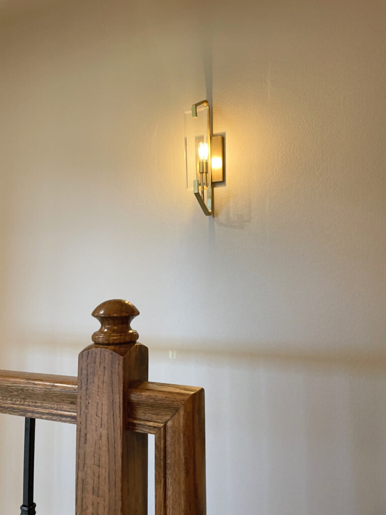 Gold wall sconce with glass front accent