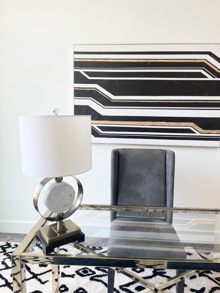 gold, black, and grey glamorous office decor with abstract desk lamp