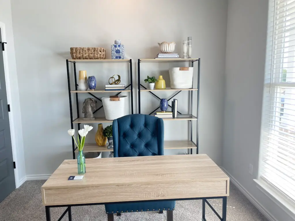 Modern farmhouse office with open shelving and blue chair