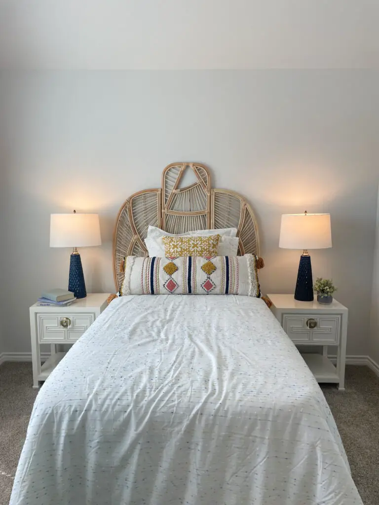 Bamboo & wicker headboard on a twin bed with white, blue, pink, and yellow decorative accents
