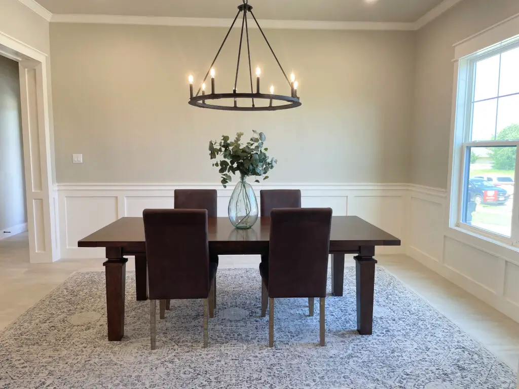 Dark brown table and accent chairs with black chandelier