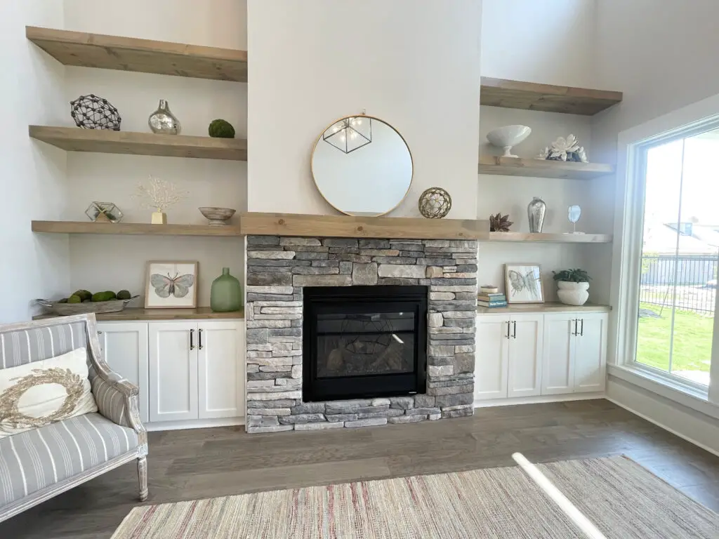 Stone fireplace with built ins and open shelves surrounding it