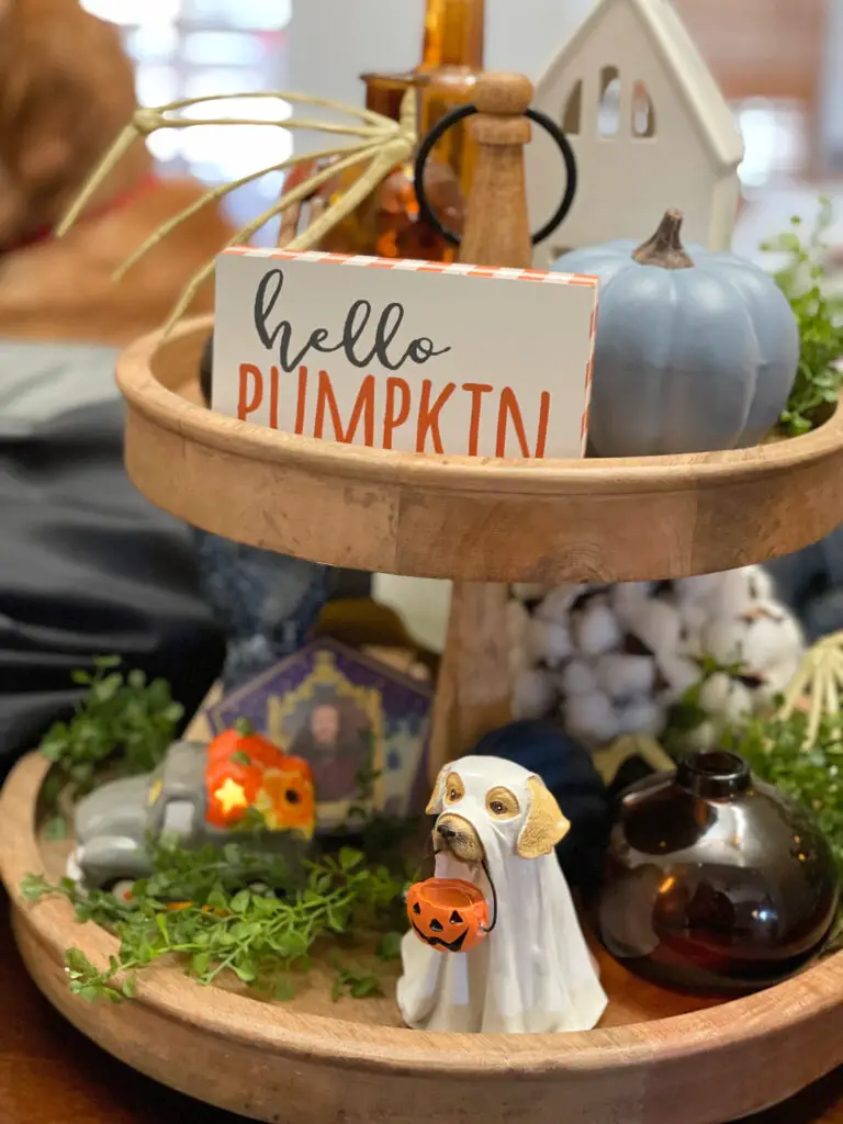 Two-tiered tray with a mix of fall decorations and Halloween knickknacks