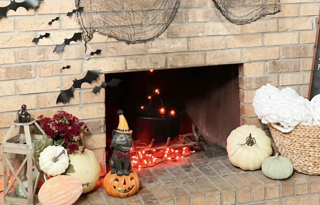 Pumpkins and Halloween decor adorned on the base of a fireplace