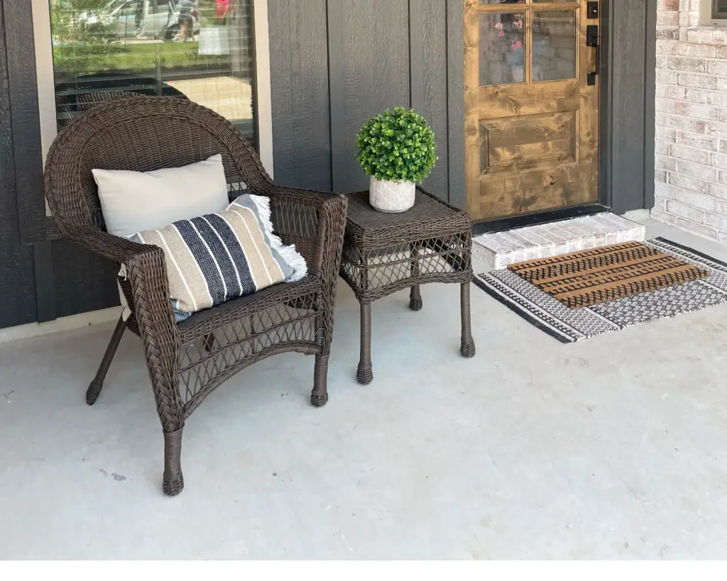 Brown wicker chair on patio with pop of blue and green