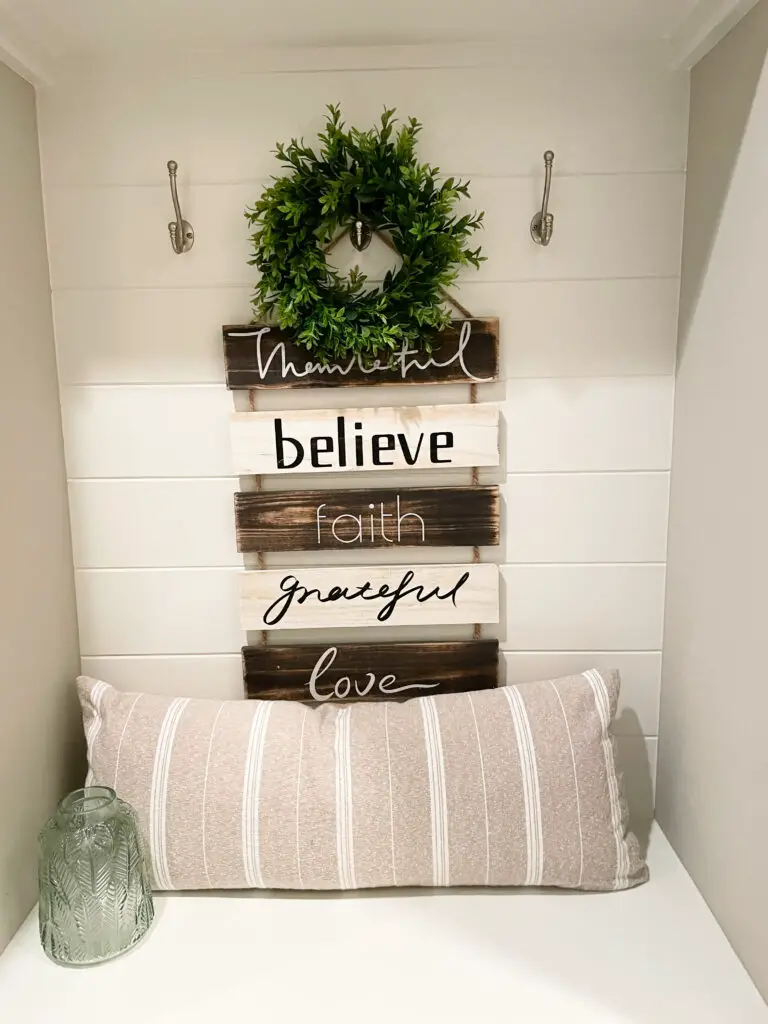 hanging word sign on mudroom bench