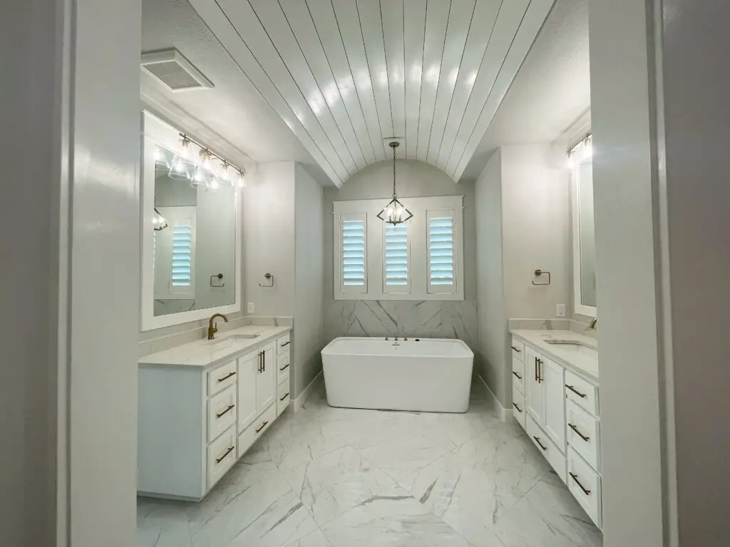 white bathroom with arched shiplap ceiling