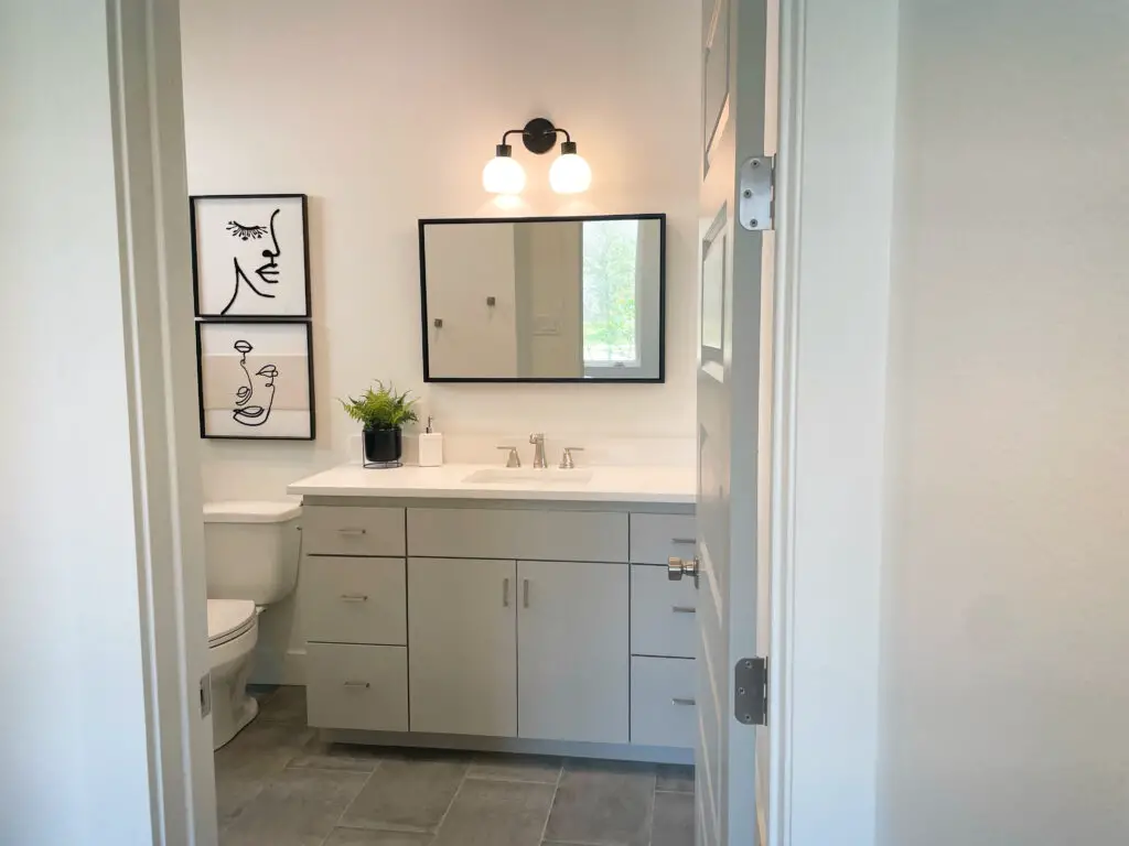 grey vanity with grey tile floors in modern bathroom