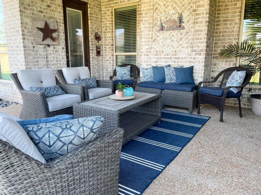 upscale patio design with brown wicker furniture and blue decorative accents