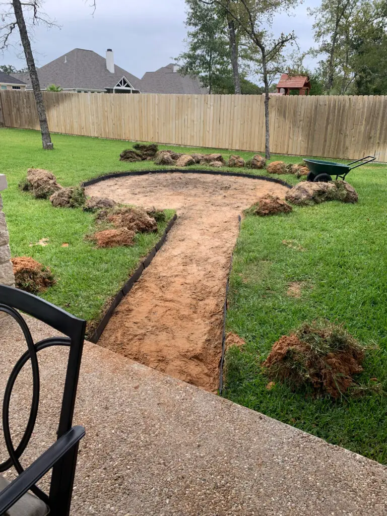 dirt outline for fire pit with grass around it