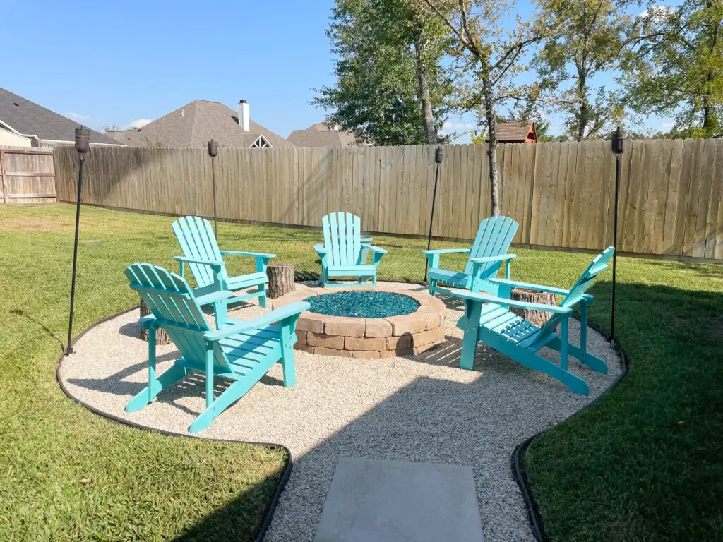 teal chairs around beautiful fire pit