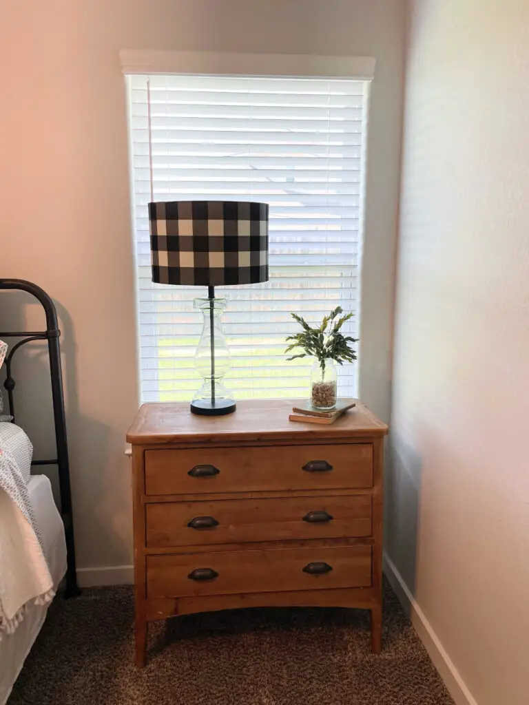 farmhouse black lamp with book stack and plant on top