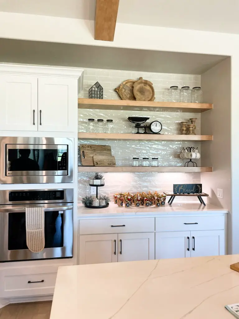 open shelves in a white kitchen with rustic decorations