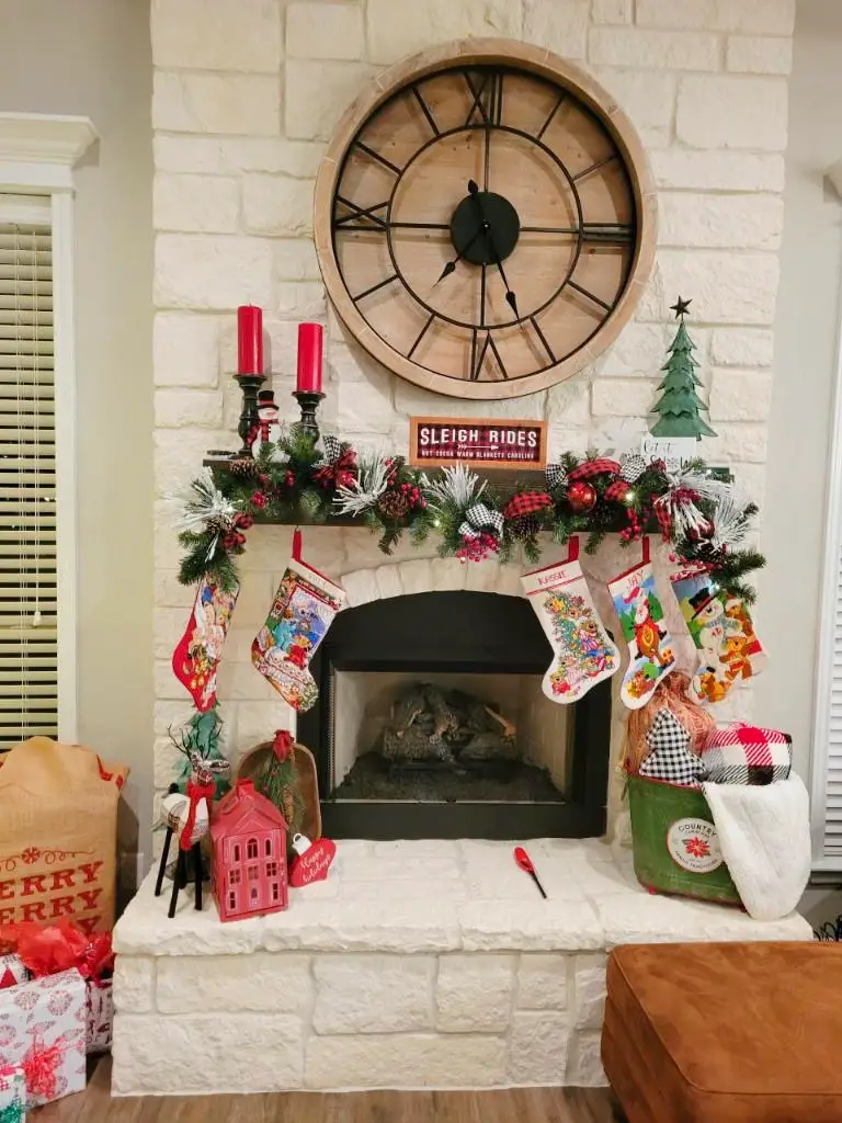 fireplace mantle with colorful buffalo check garland and Christmas accents