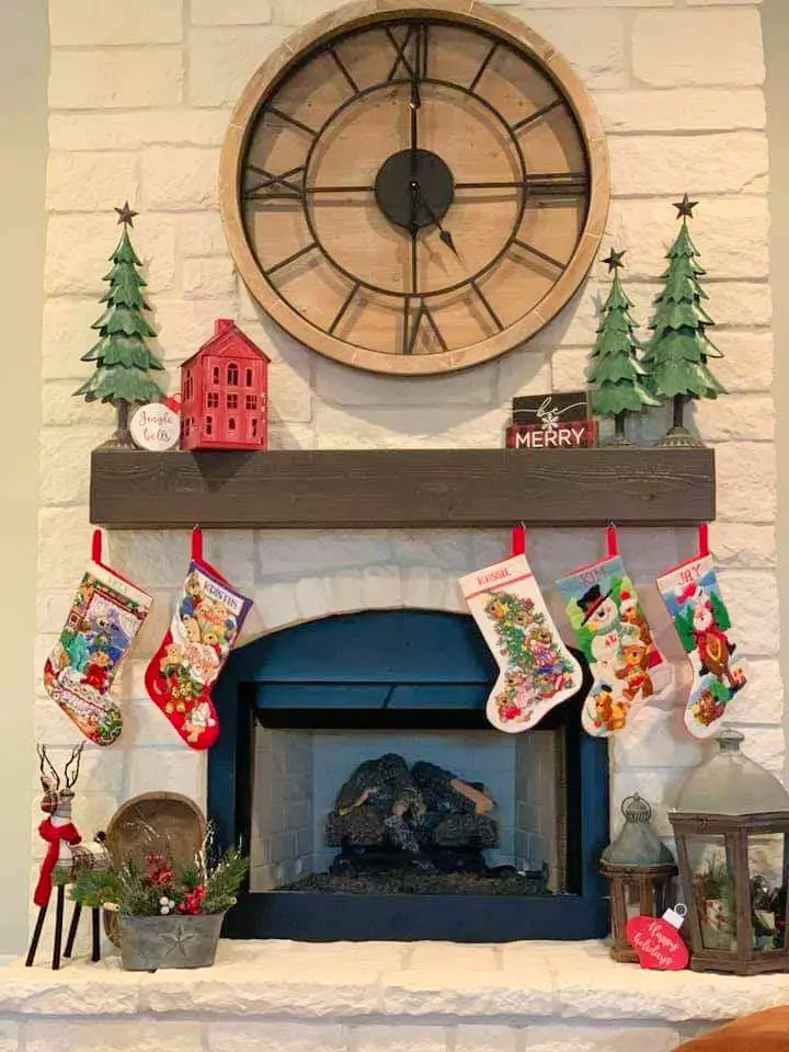 Fireplace mantle with red, green and black decorative accents