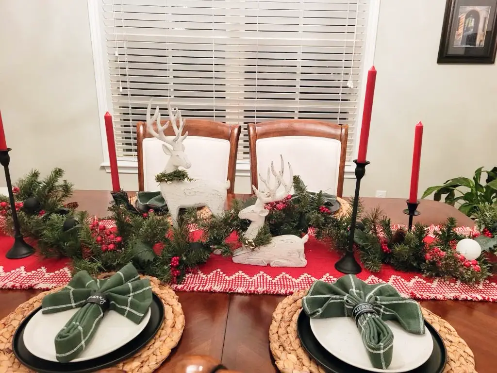 Christmas tablescape with garland, candles and more
