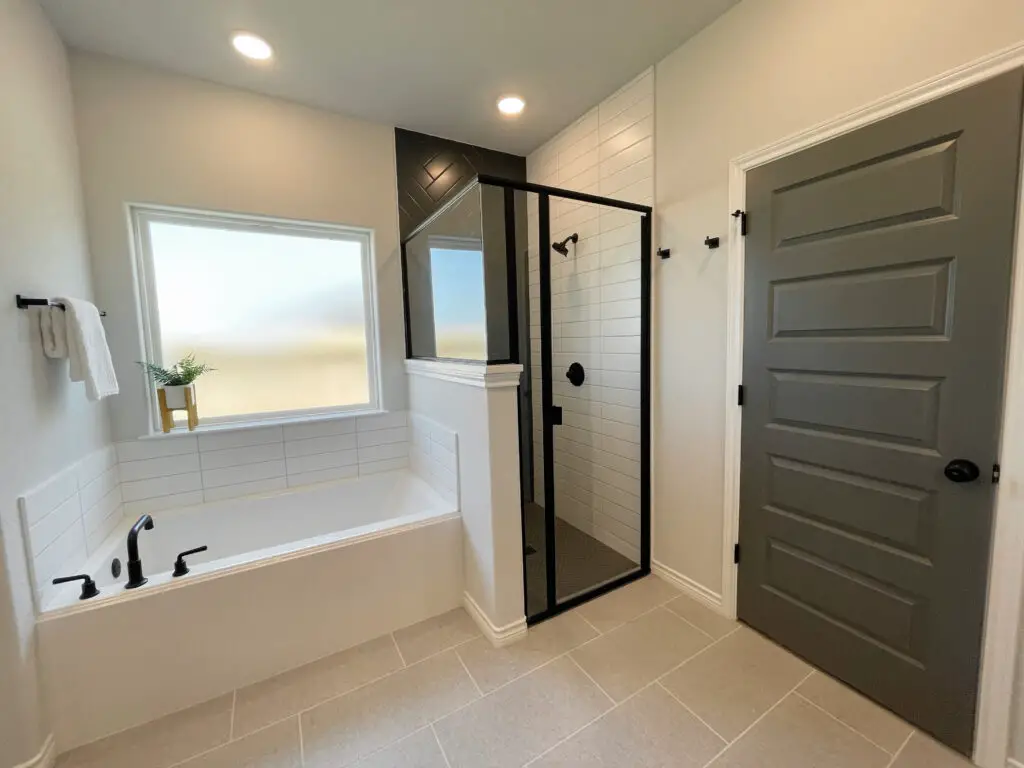 black white and grey bathroom design with a small shower