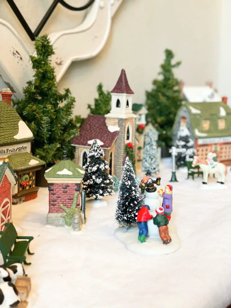 Children playing in the snow in Christmas village