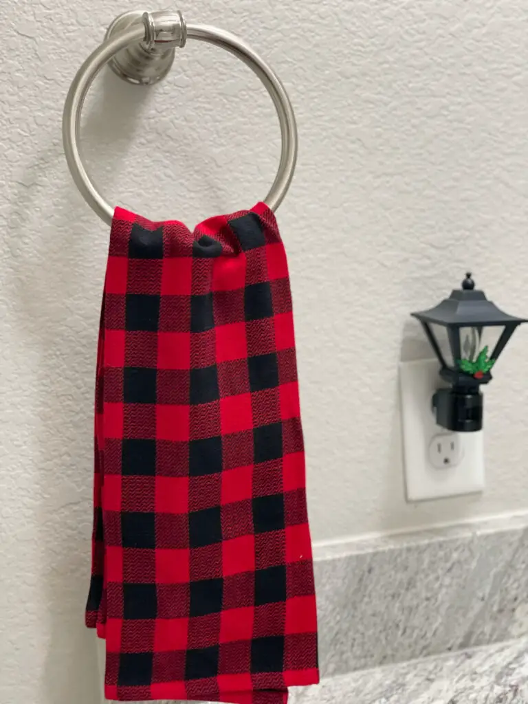 red and black Christmas towel on bathroom towel ring