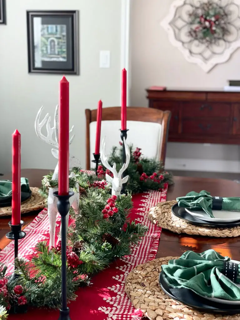 Christmas garland utilized at red and green Christmas table setting