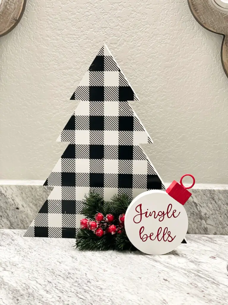 Black and White Christmas tree sign with jingle bells decoration on bathroom counter
