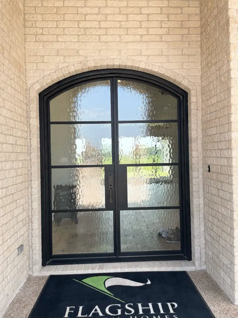 arched front door way with brick exterior