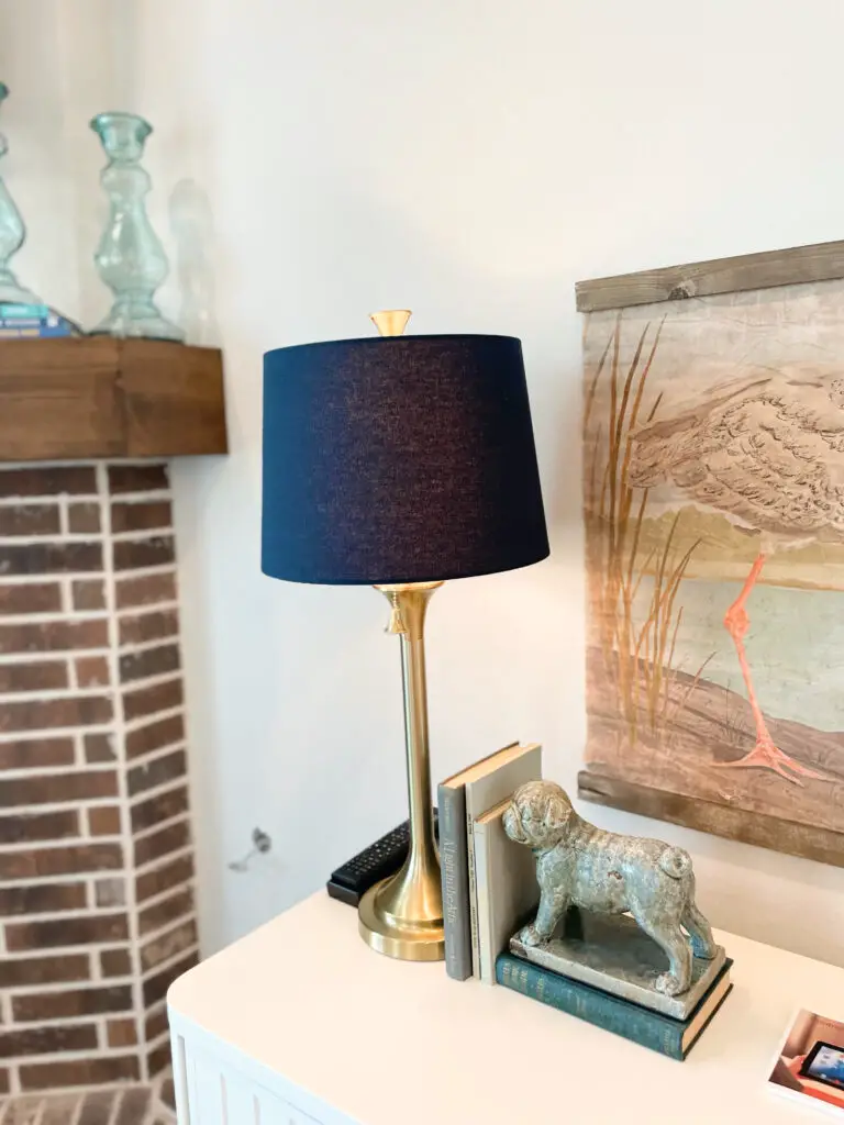 blue lampshade on gold lamp in eclectic living room