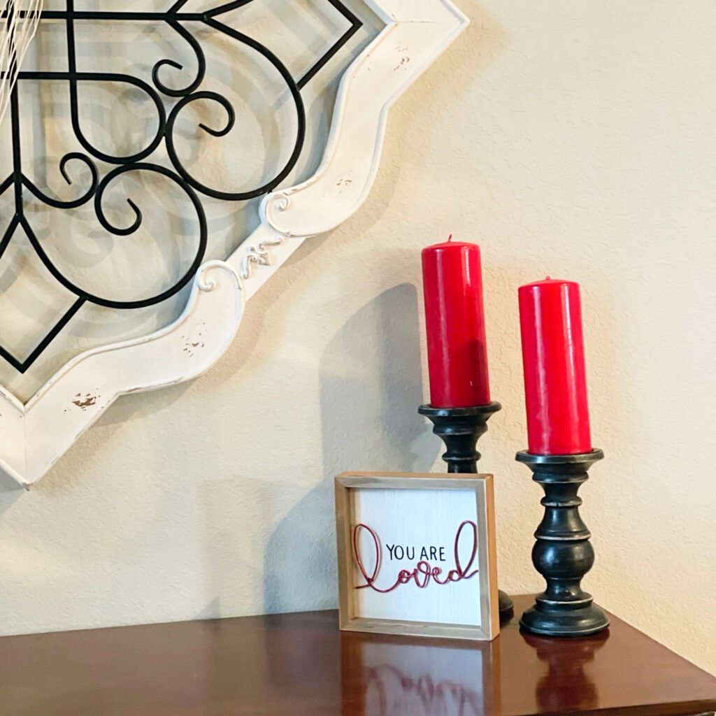 red candles next to Valentine's Day sign