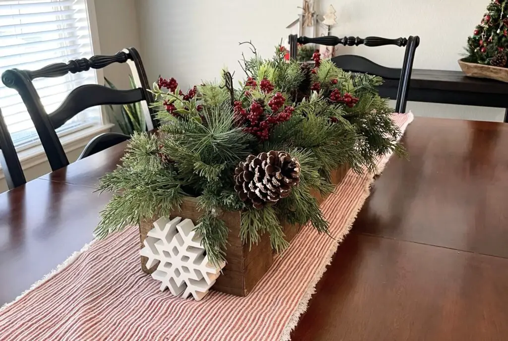 Red and white table runner with winter decorative box