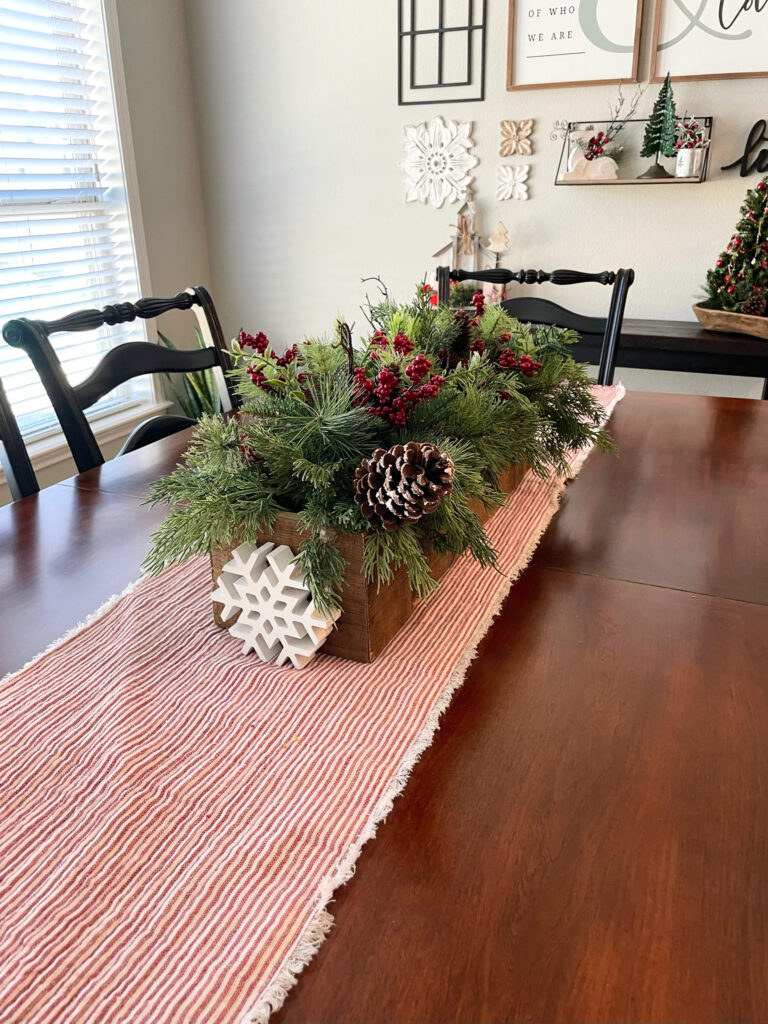 red and white table runner under decorative winter box